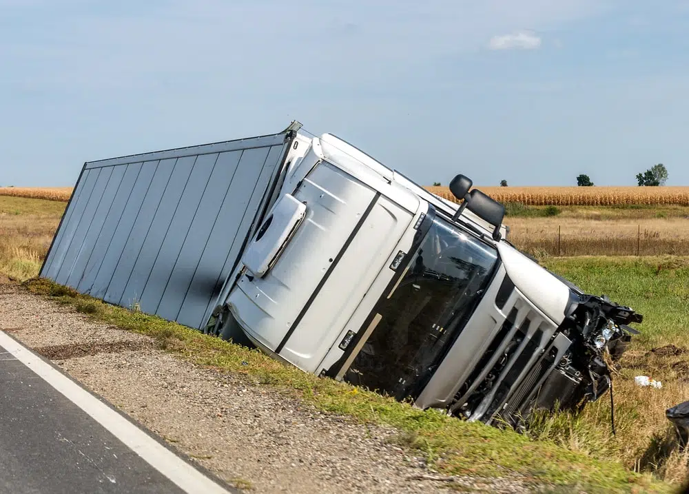 Truck Accident White truck tipped over in a ditch