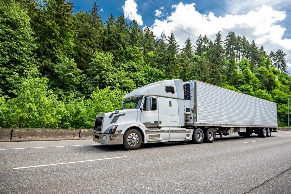 18-Wheeler Truck White 18-wheeler truck driving on highway