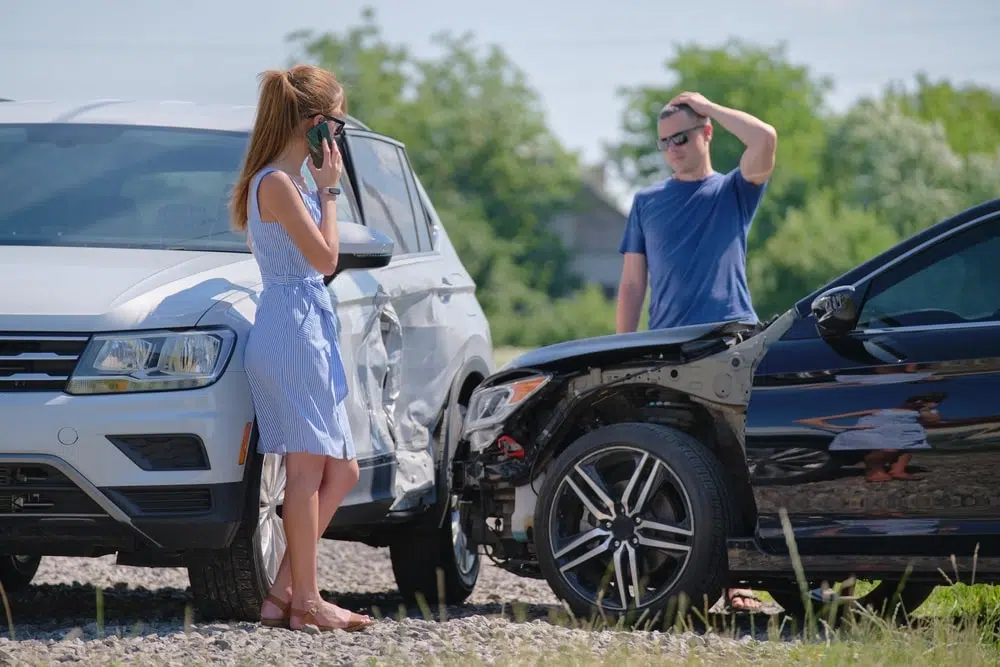 T-Bone Car Accident Drivers of smashed vehicles arguing who is guilty in car crash accident on street side.